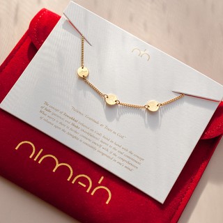 Arabic bracelet in gold with 'Happiness' engraved in it's packaging