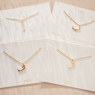 Arabic Letter Necklace Displayed Showing 5 Gold Letter Variations For The Necklace 