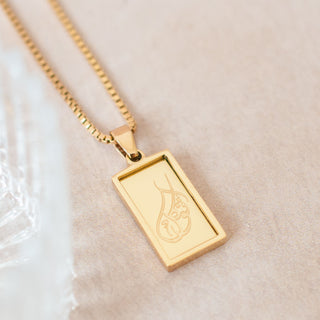 Close Up of Nimah Tawakkul Necklace With Arabic Calligraphy