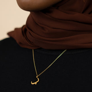 image of model wearing 18K gold plated Arabic letter necklace