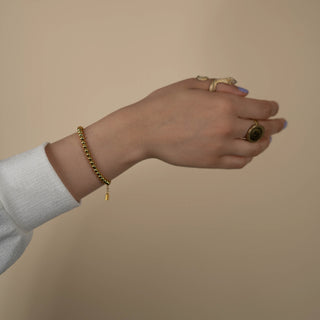 Model wearing beaded gold Arabic bracelet